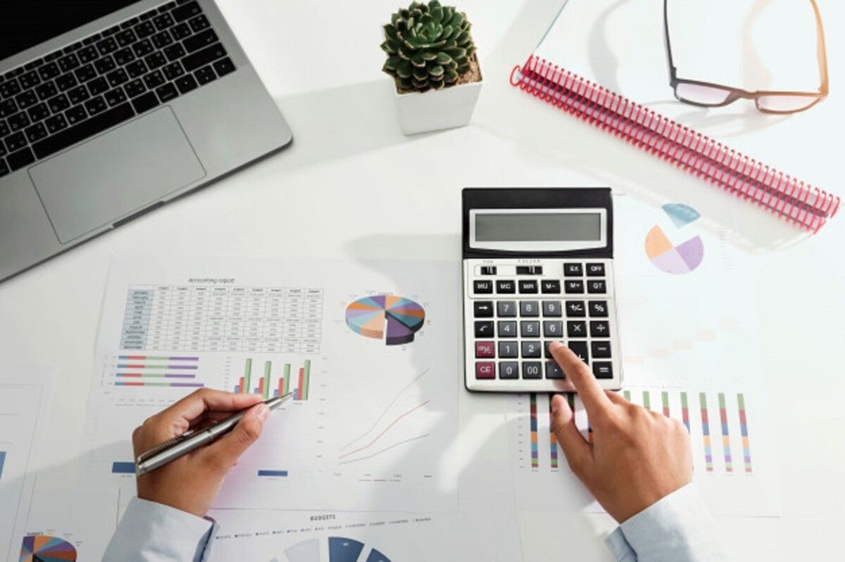 businesswoman working desk using calculator laptop analyzing finance accounting office 34152 2162