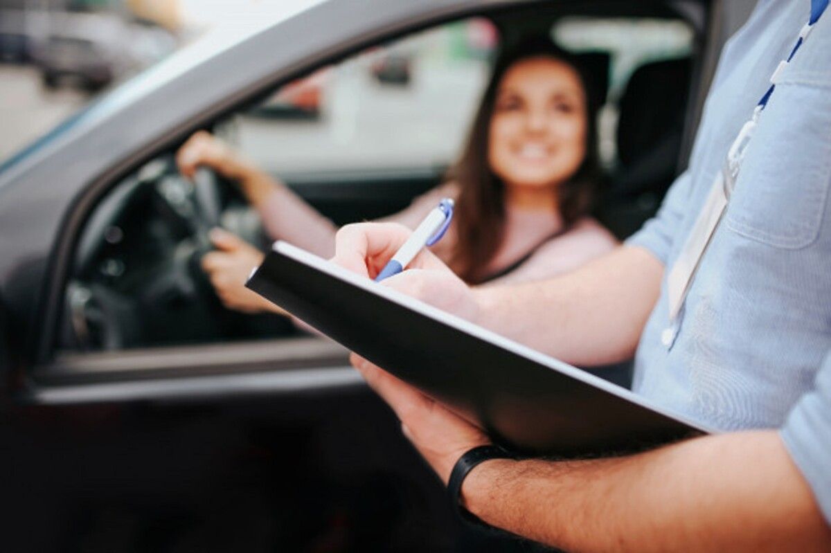 male auto instructor takes exam young woman blurred model sitting car holding hands steering wheel guy hold folder with paper hands 152404 9254 1
